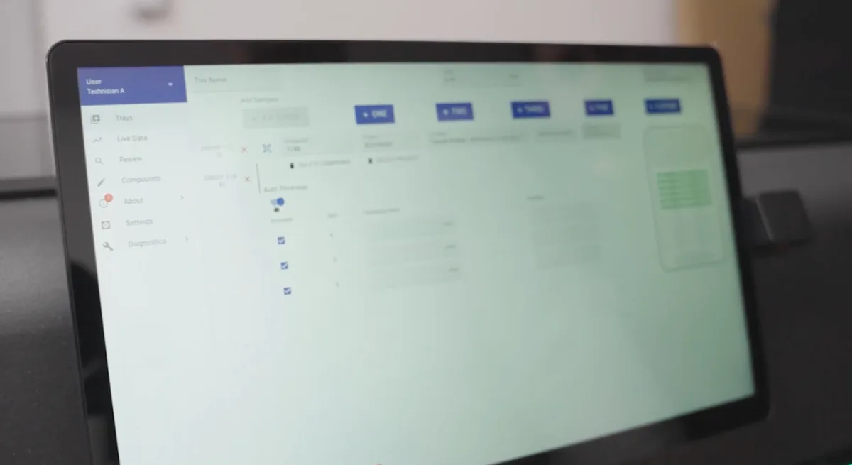 User's hand interacting with the LabsCubed touchscreen interface, demonstrating intuitive control of automated tensile testing parameters.